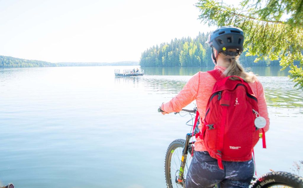 [Alt text: A young cyclist is looking at lake.]