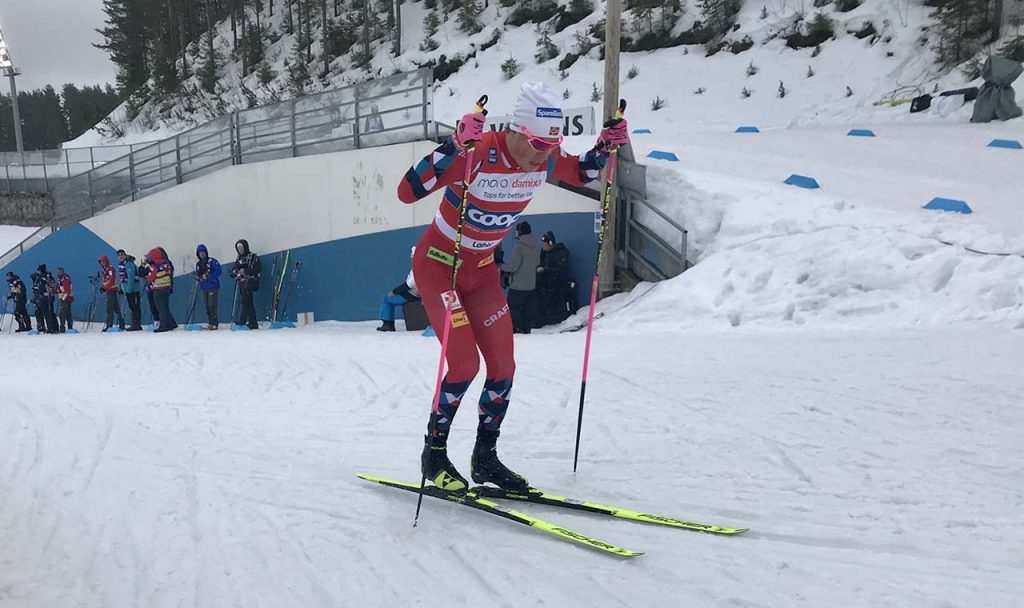 [Alt: a male athlete is skiing.]