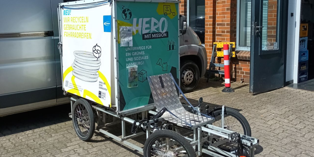 Sähköavusteinen polkupyörä, johon on kiinnitetty kontti tavaran kuljetusta varten.