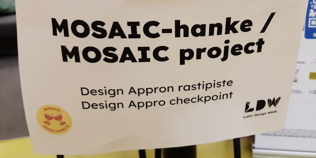 Kuva lapusta, jossa lukee MOSAIC- hankkeen rastipiste Design Approssa