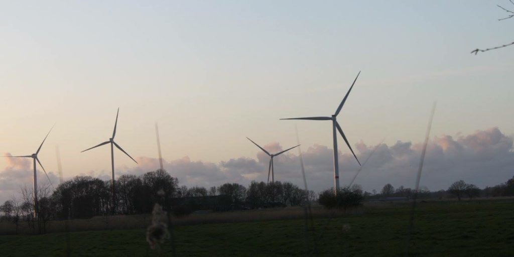 Four wind turbines in the German countryside.