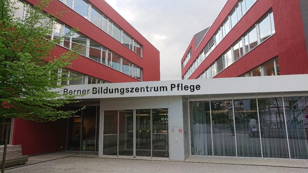 [Alt text: The main doors of a huge building with text berner bildungszentrum pflege.]