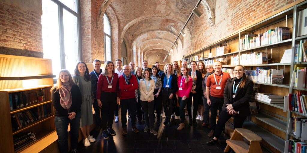 A group of people in a library building.