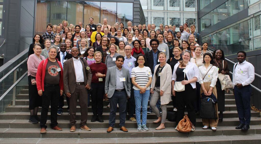 [Alt text: a big group of people standing on stairs.]