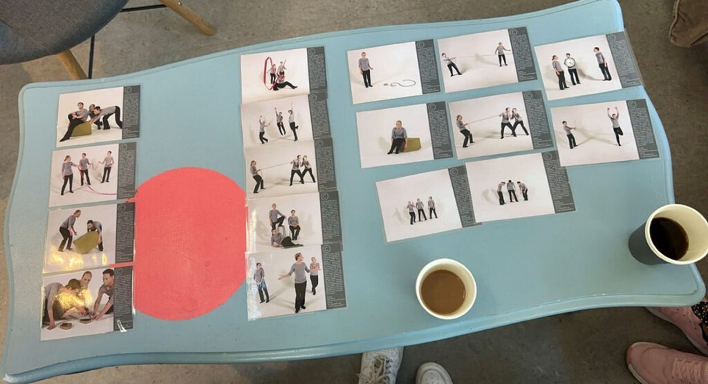 [Alt text: several pictures on a table, pictures are presenting people acting and communicating in different situations.]