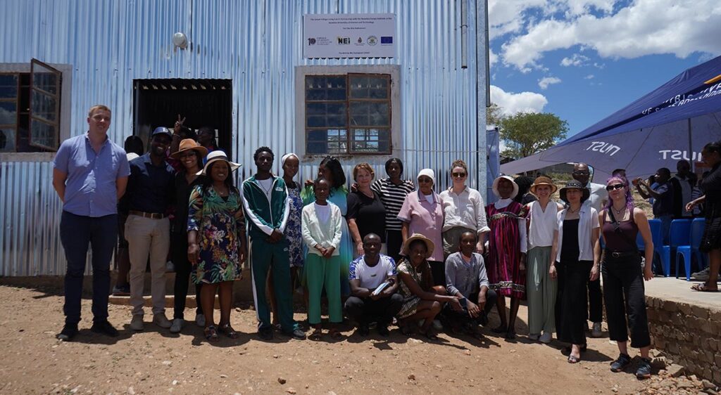 [Alt text: a group of people standing in front of a building.]