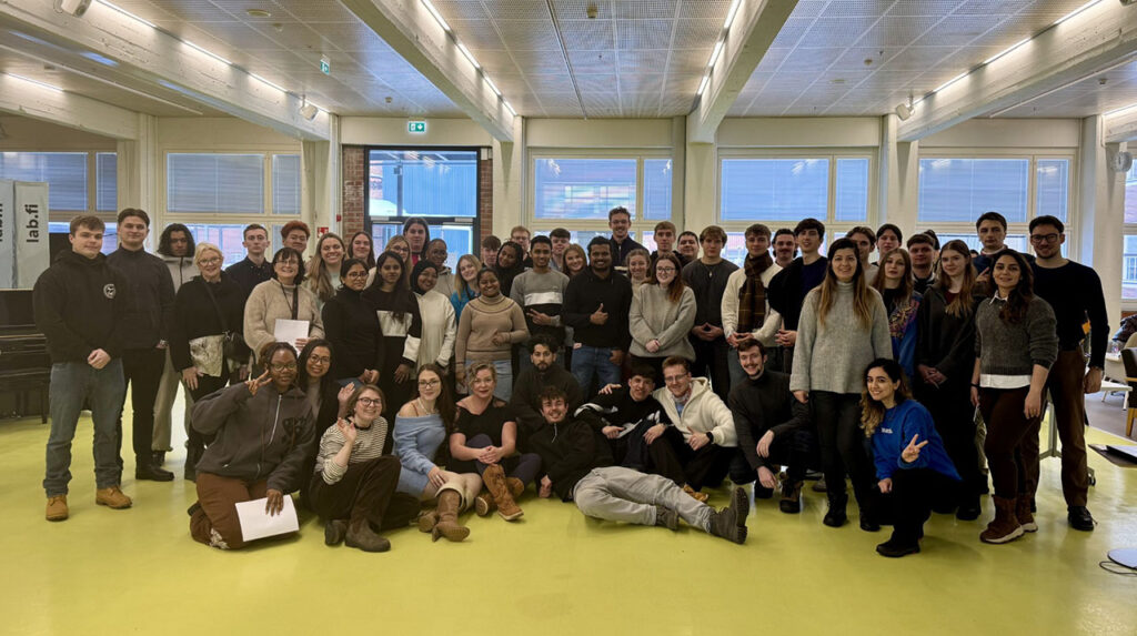 [Alt text: a large group of people at university hall.]