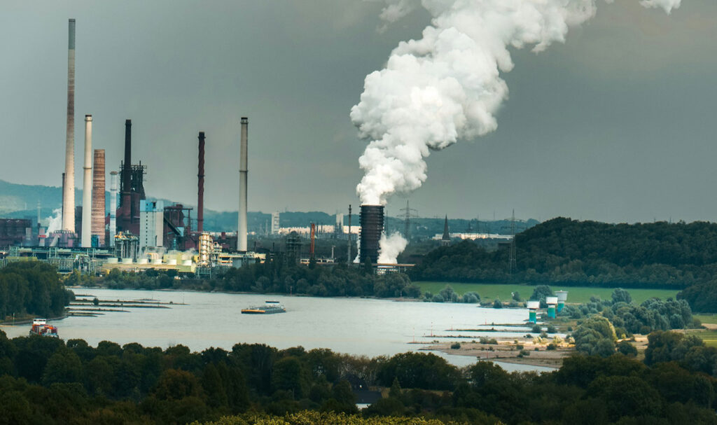 [Alt text: A view of polluting factors at a lake shore.]