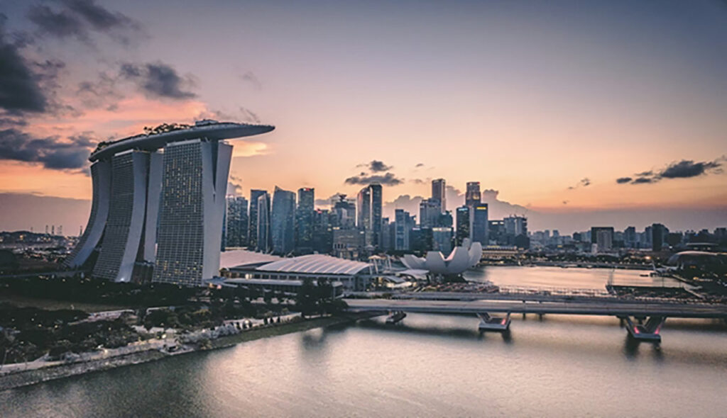 [Alt text: an urban skyline with high buildings and the shore.]