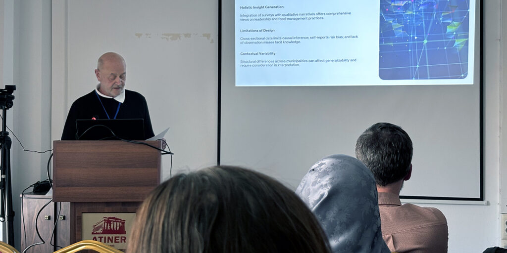 A older gentleman delivering a keynote speech at a conference room.