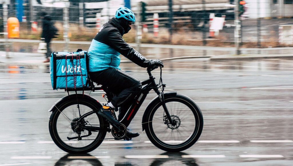 [Alt text: a cycling courier in the city.]