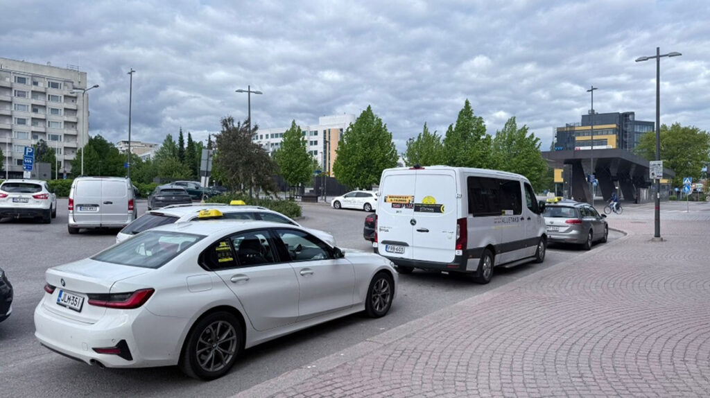 [Alt text: several taxi vehicles in line.]
