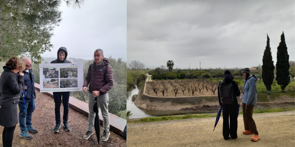 On left, There are four people standing outside. One is holding a sign presenting a project and other one is explaining. On right, a ravine with cultivated crops behind it.